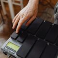 Close-up of a hand playing the MalletKat electronic percussion instrument indoors.