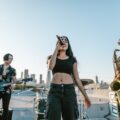 Live music band performing on a rooftop with skyline view at sunset. Energetic and vibrant atmosphere captured perfectly.