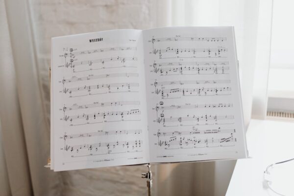 Elegant sheet music on a stand with soft natural light pouring through the window.