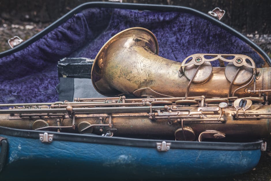 Closeup of a vintage brass saxophone in a velvet-lined case, highlighting its antique design.