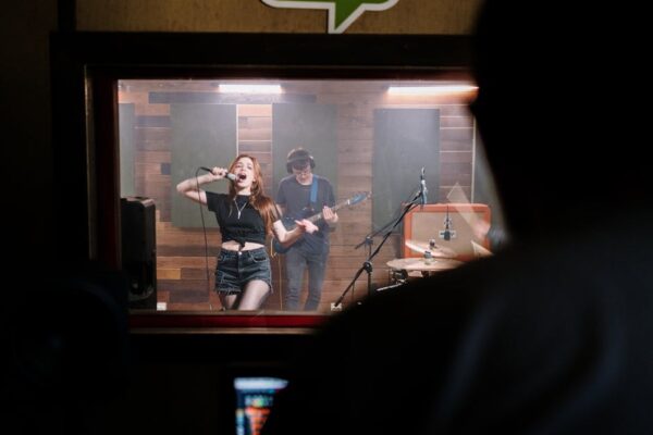 A dynamic band performance captured in a professional sound studio setting.