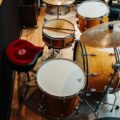 Overhead view of a drum set in a music studio with vintage wooden design.