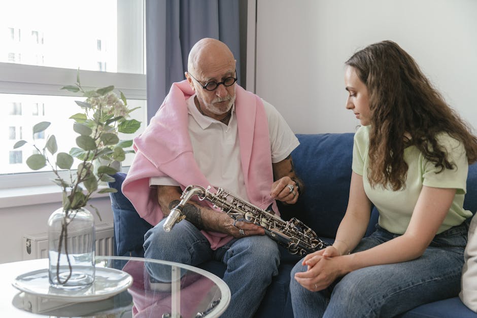 An elderly man instructs a young woman on saxophone in a cozy indoor setting.