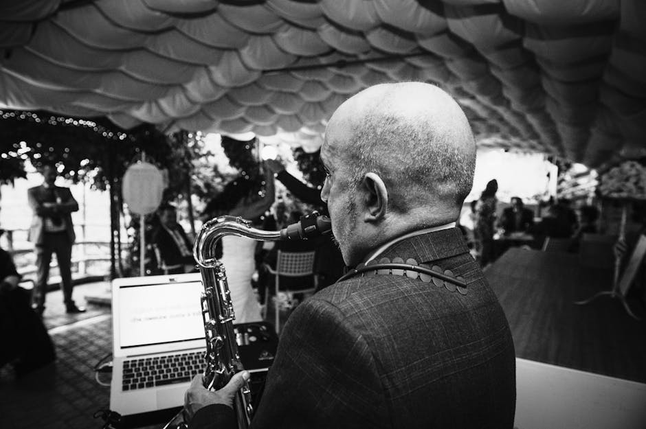 Black and white photo of saxophonist performing at an outdoor event in Bergamo, Italy.
