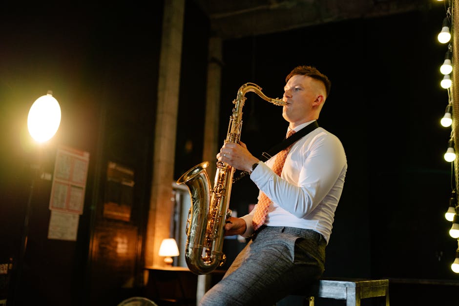 A musician passionately playing the saxophone indoors, wearing a button-down shirt and necktie.