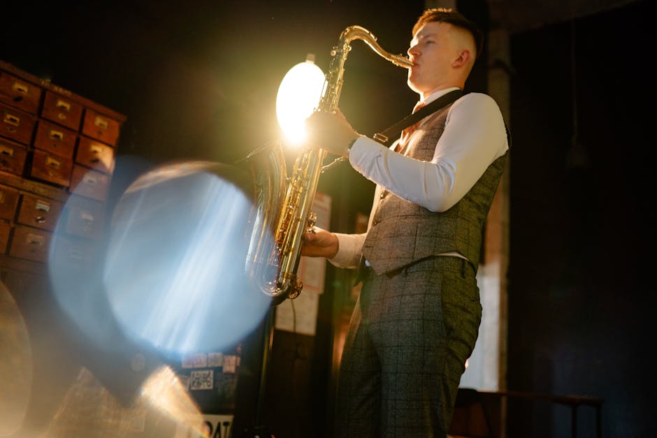 A jazz musician plays the saxophone in a dimly lit room with a spotlight.
