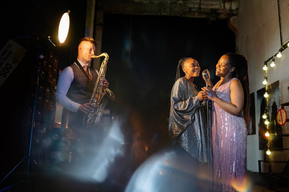 Group of musicians performing with saxophone and microphone under soft lights, exuding elegance and joy.