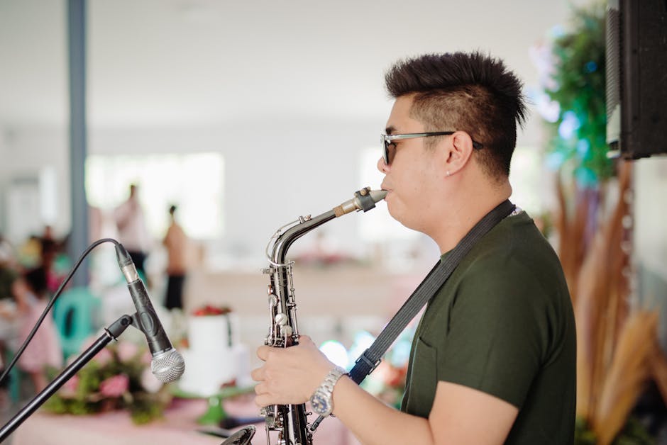 Musician performing with saxophone at an indoor gathering, blurred background