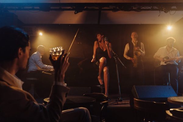 A vibrant jazz band performing live on stage with a singer in a cozy bar ambiance.