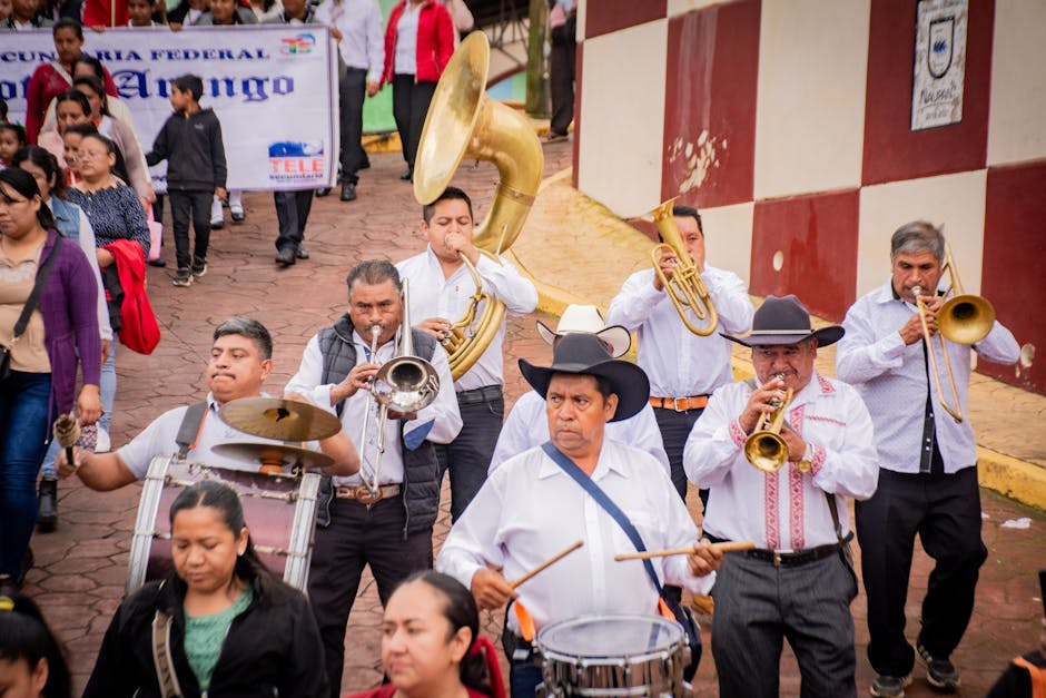 Vibrant street parade featuring a brass band performance with male and female participants.