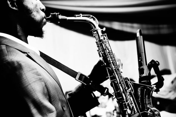 Close-up of saxophonist performing, highlighting musical passion.