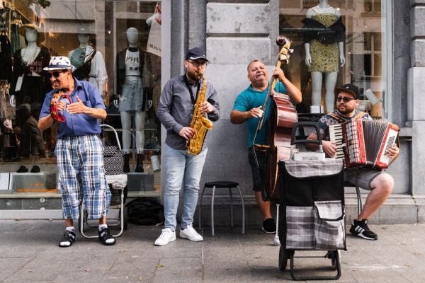 Street musicians in Antwerp energizing the crowd with live music.