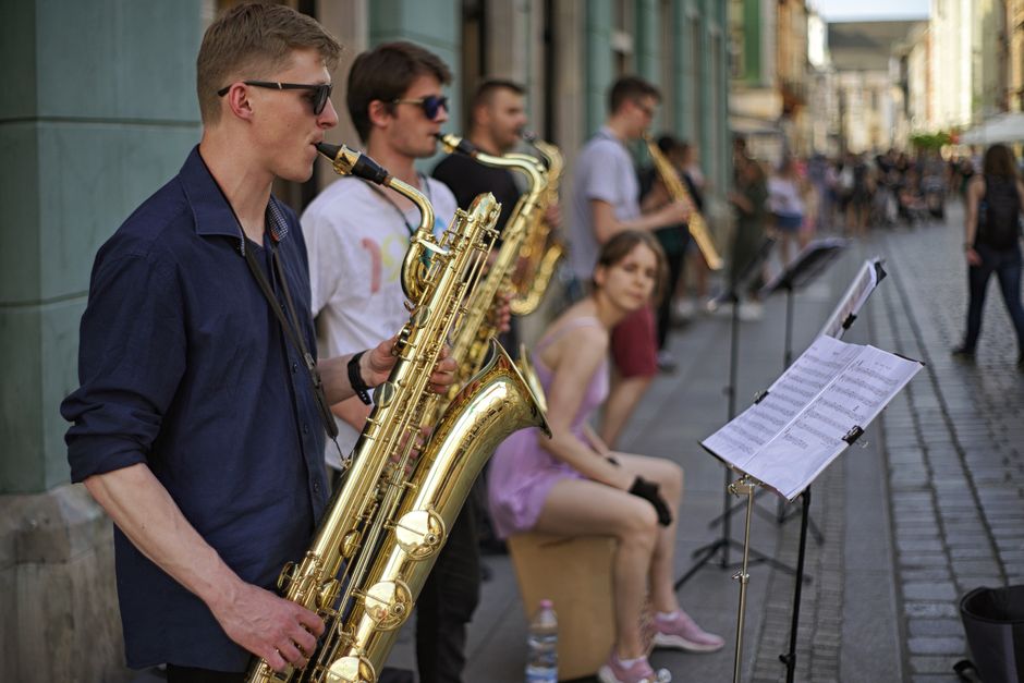 Vibrant street performance featuring a group of saxophonists in Wrocław, Poland.