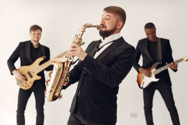 A lively jazz band playing different instruments on stage, creating a vibrant musical atmosphere.
