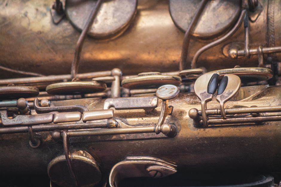 Detailed view of an antique saxophone showcasing intricate metal keys and brass texture.