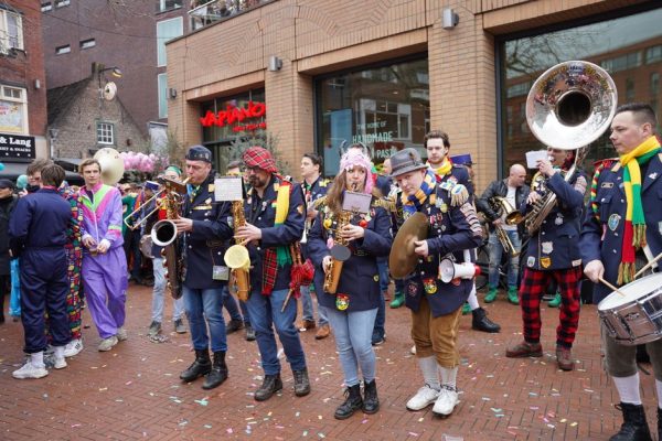 Colorful street band performing during a vibrant carnival parade in Holland.
