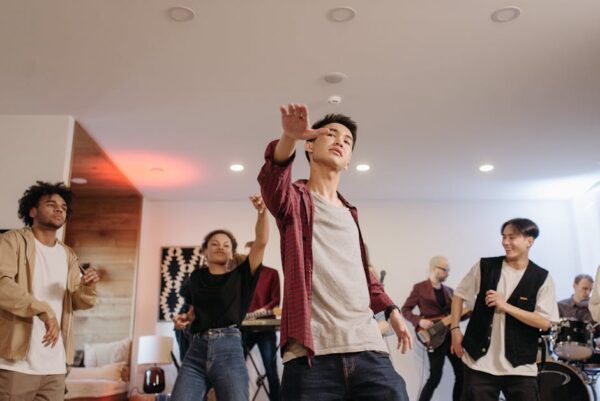 Dynamic group of friends enjoying a lively indoor party with live music and dancing.