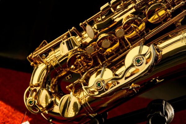 Detailed close-up of a shiny gold saxophone showcasing intricate details and reflections.