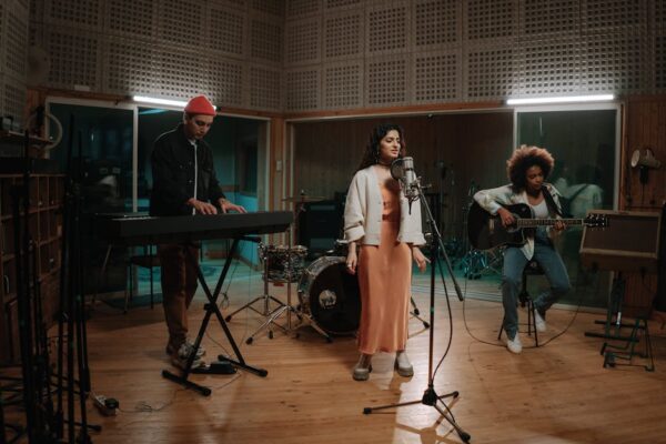 A diverse group of musicians rehearsing in a professional music studio, showcasing creativity and collaboration.