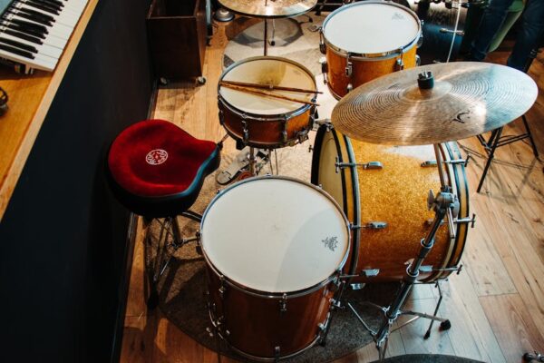Overhead view of a drum set in a music studio with vintage wooden design.