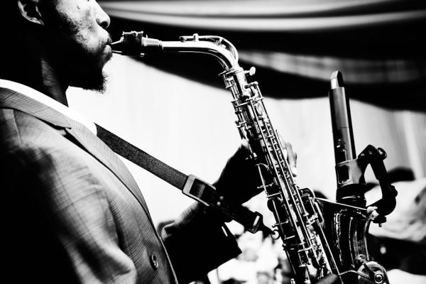 Close-up of saxophonist performing, highlighting musical passion.