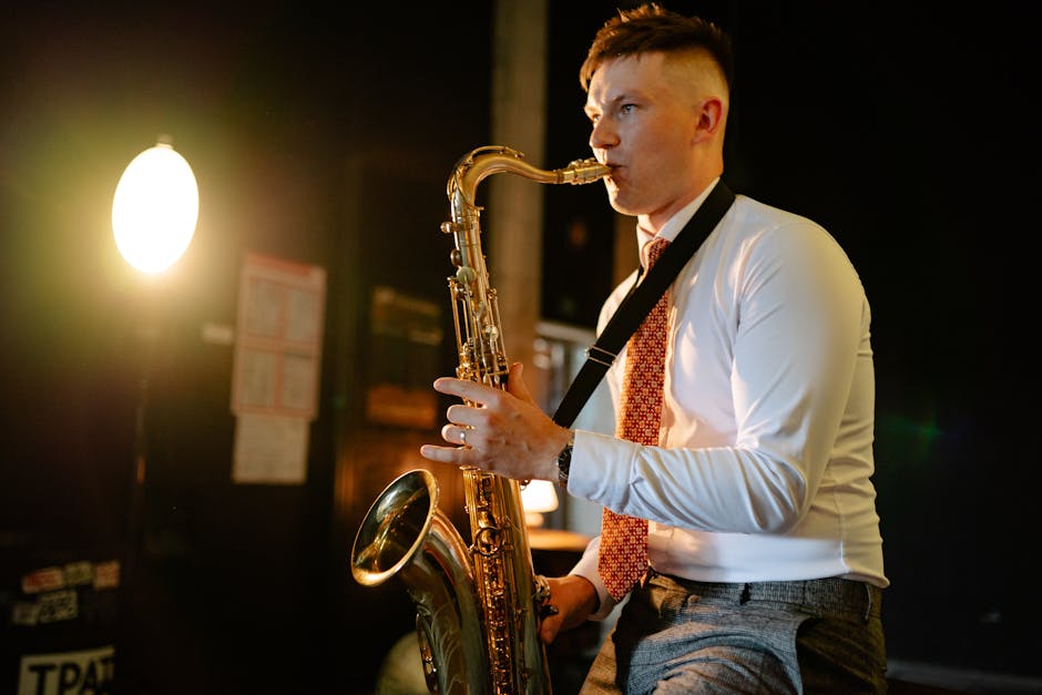A man playing saxophone under warm lights, creating a cozy musical ambiance.